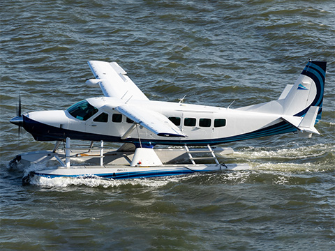 Amphibious Cessna Caravan taxiing on the water