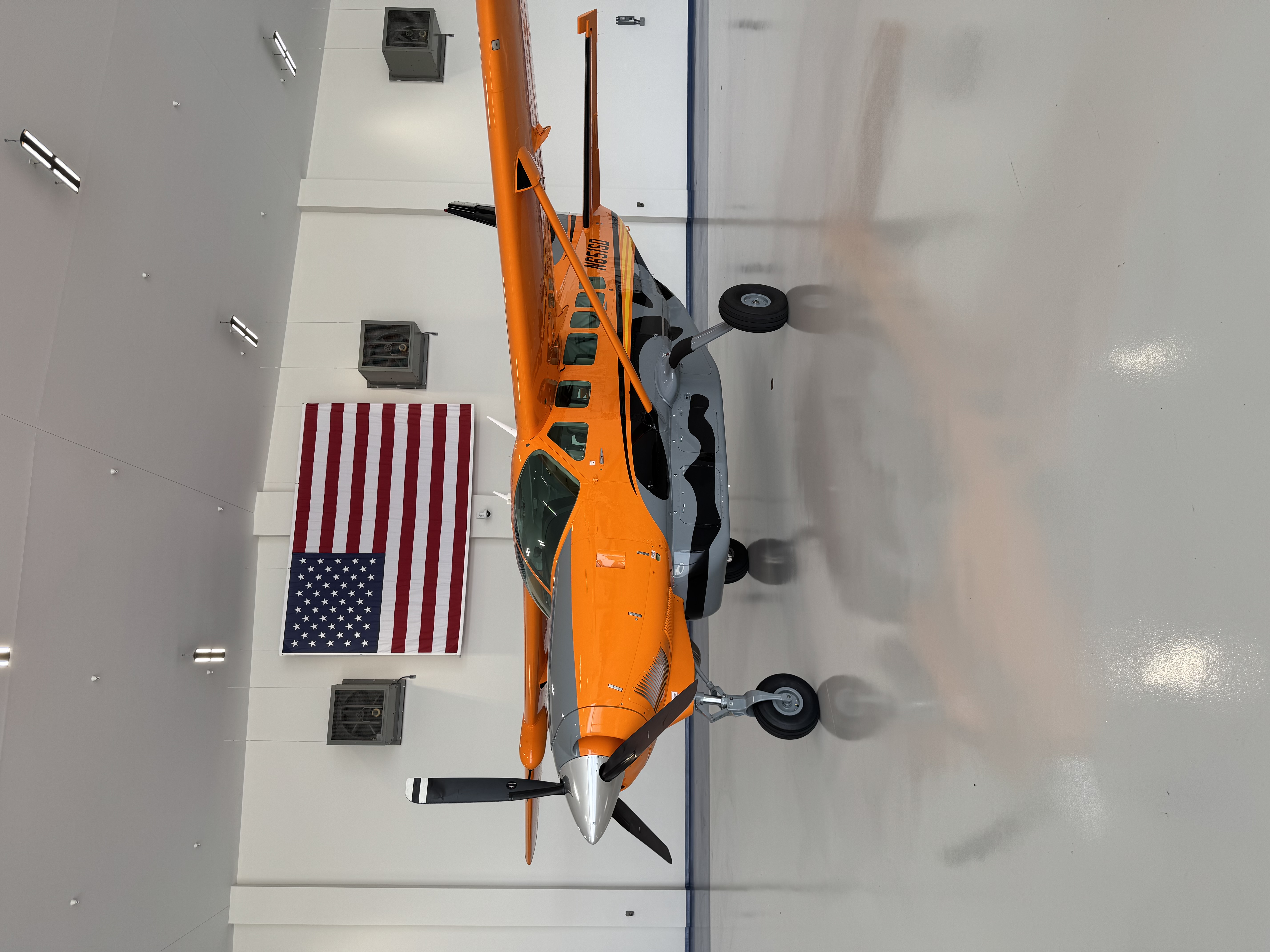 Orange Cessna Caravan inside the hangar