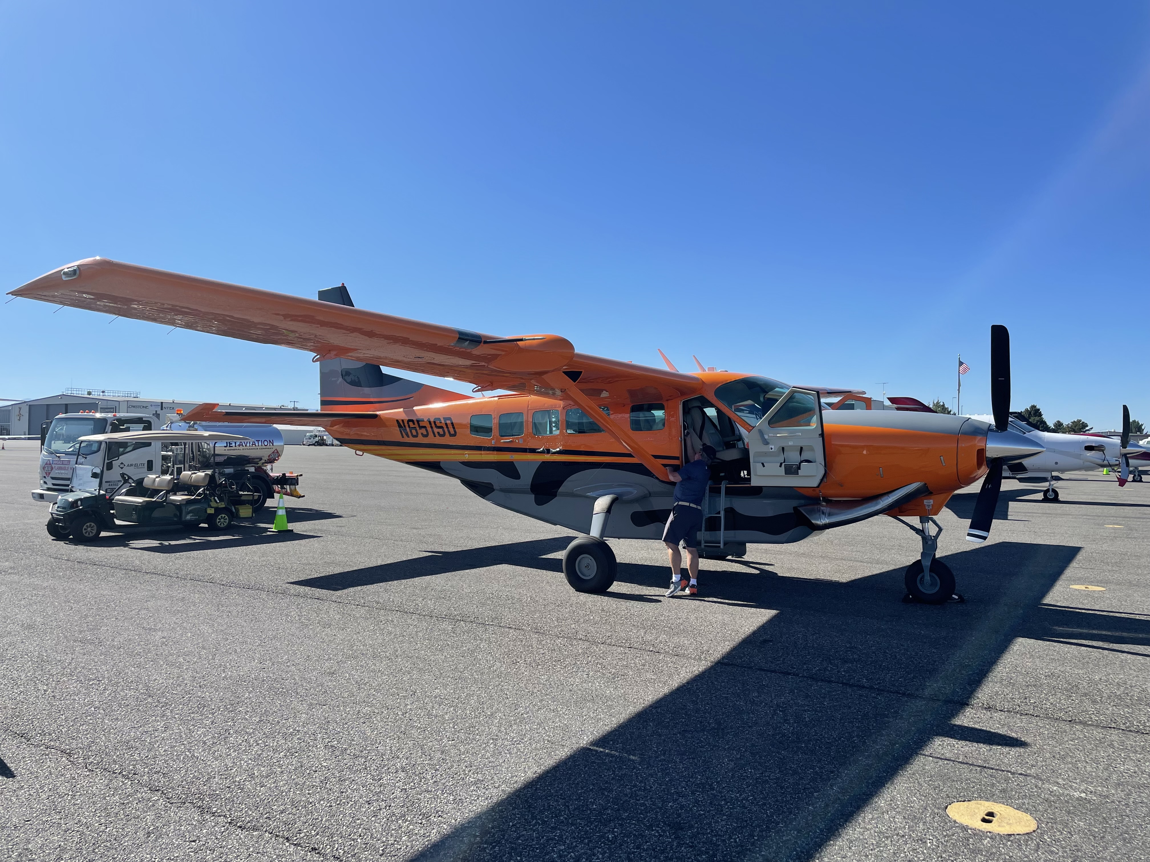 Orange Cessna Caravan being loaded on the ramp