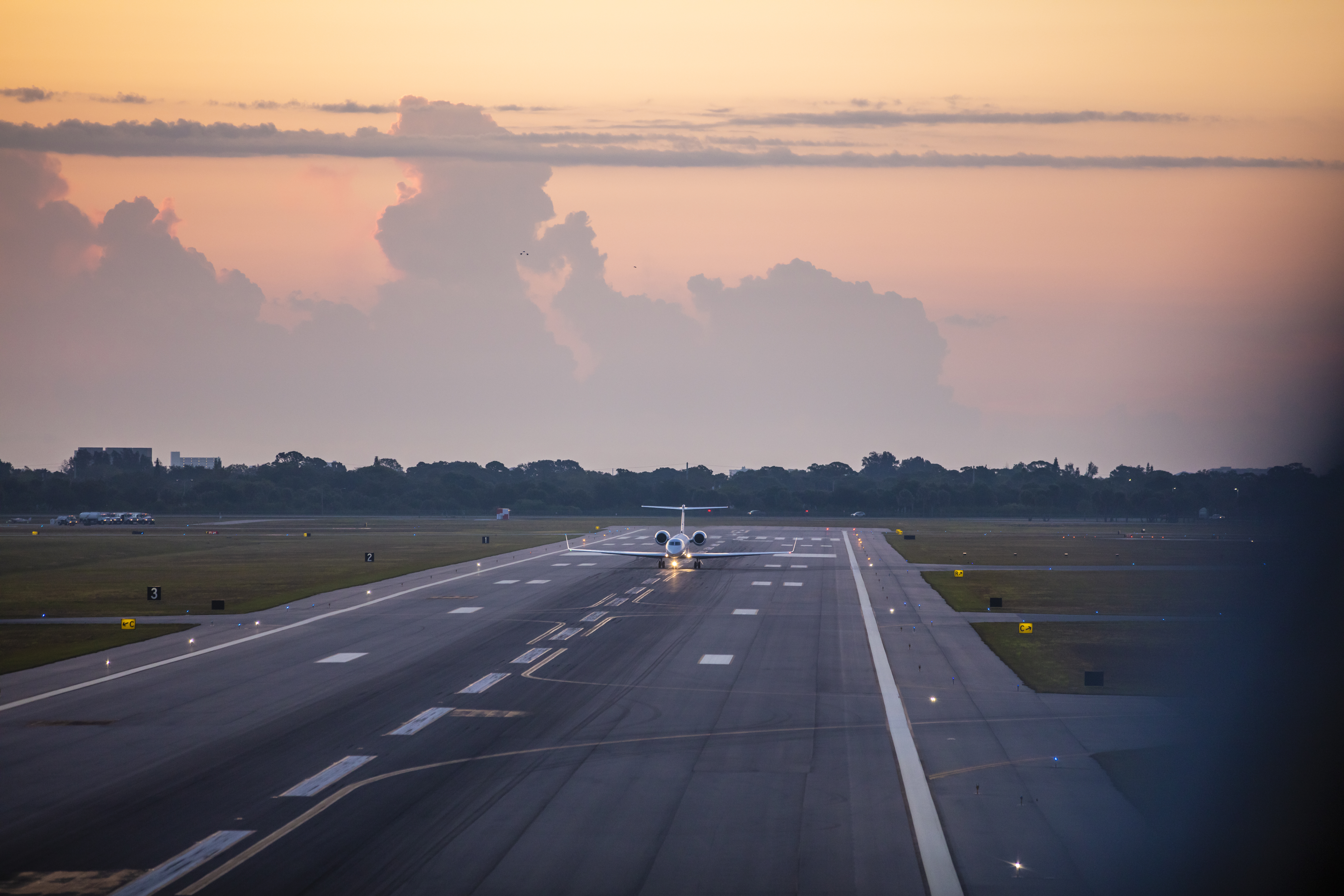 Gulfstream G550 taxiing on the runway at sunrise