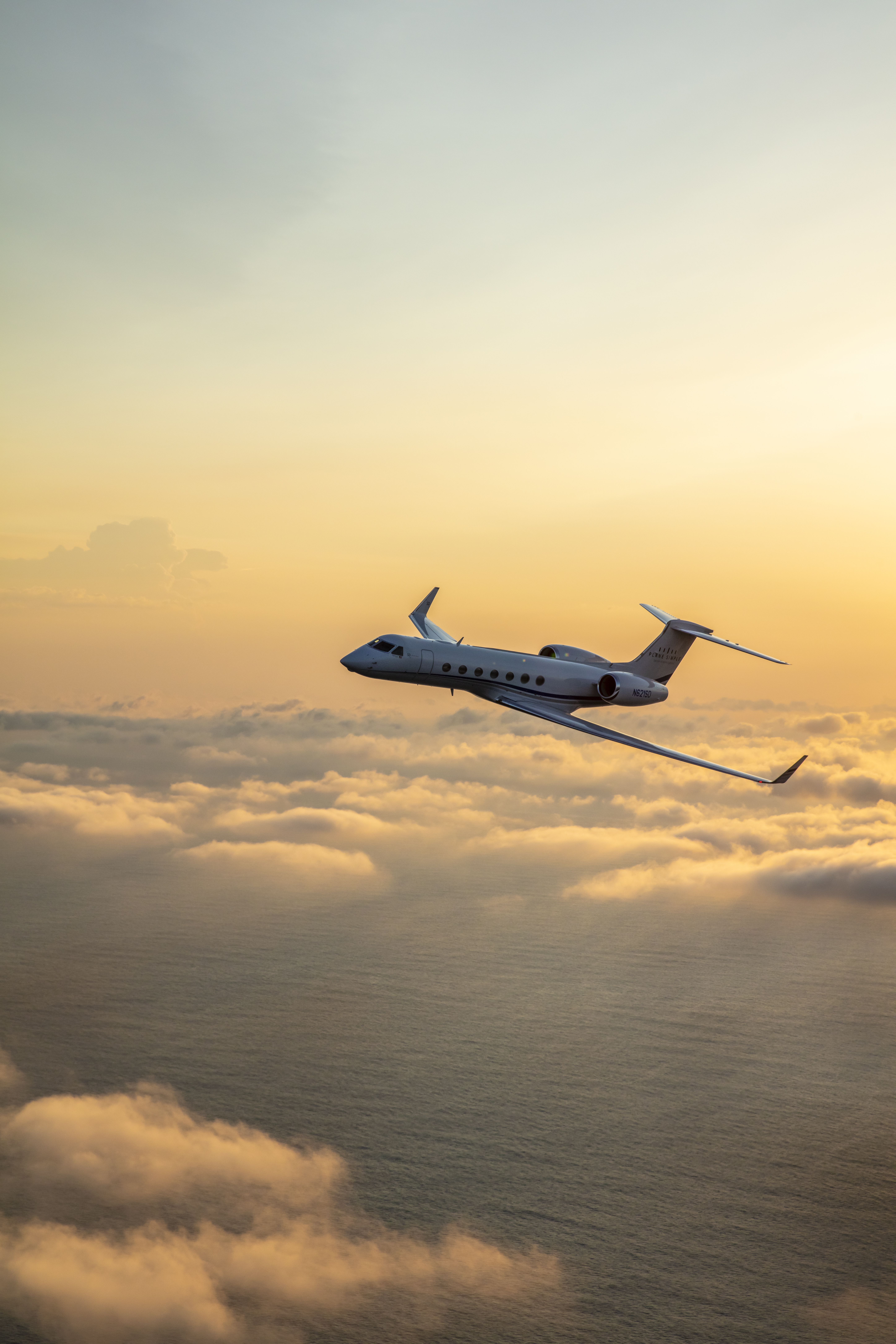 Gulfstream G550 flying above the clouds at sunset